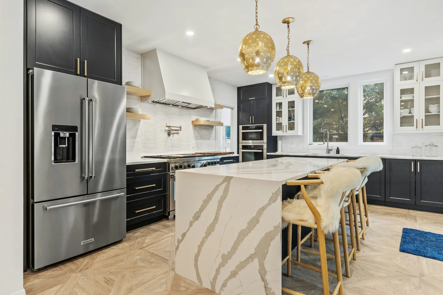 A modern home kitchen with stainless steel refrigerator and cooking appliances
